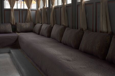 The sofa, made in an Oriental style, is located in the recreation room, with curtains on the...