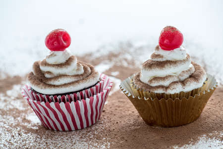 Two  Cherry Topped Chocolate cupcakesの写真素材