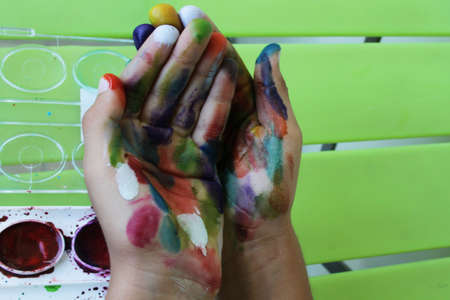 Children  s hands colored with watercolor, isolatedの写真素材