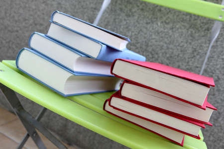 Color books on a green chair, isolatedの写真素材