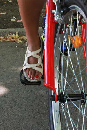 Close-up picture of a bicycle with a woman s foot, detail