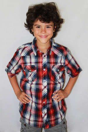 Picture of a beautiful boy posing in front of camera, isolated on grey background  の写真素材