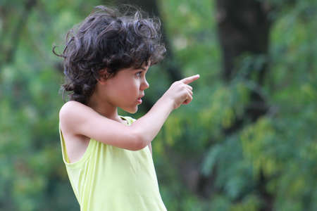 Portrait of a child pointing into the distanceの写真素材