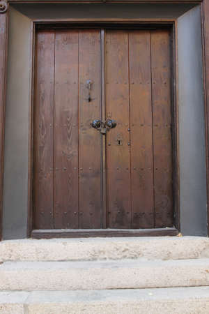 Wooden door with stone stairs in front of it