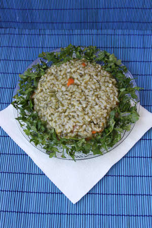 Rice with spinach and parsley isolated on blue backgroundの写真素材