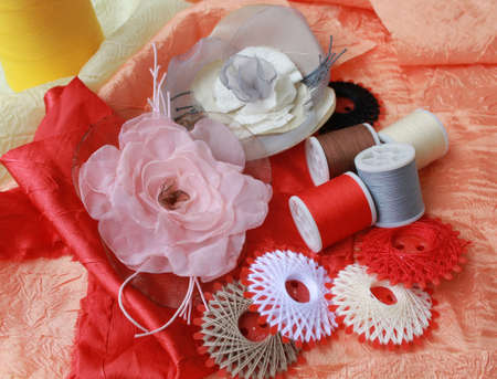 Closeup picture of threads and decorative handmade flowers