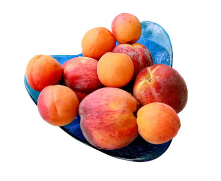 Closeup picture of peaches and apricots isolated on whiteの写真素材