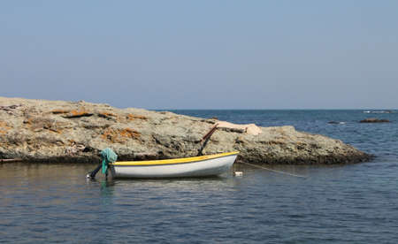 Lonely boat on rocky coast