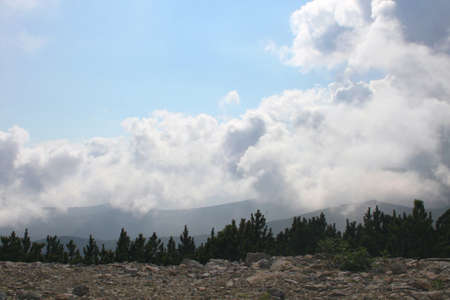 Rila mountain in Bulgaria under fluffy white cloudsの写真素材
