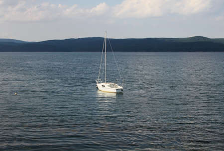 A lonely white boat in the lake