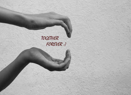 Closeup picture of hands in black and white with wordsの写真素材