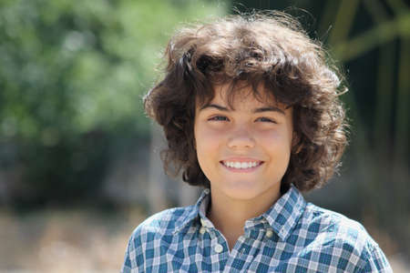 An outdoor portrait of an attractive teenage boy, facial expressions