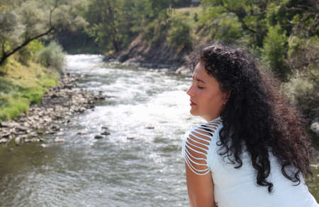 Picture of a beautiful young woman on a rusty old bridgeの写真素材