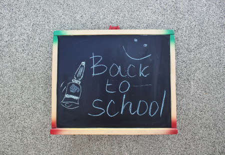 Back to school title written with chalk on a blackboard