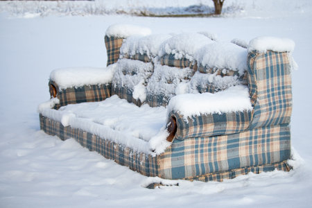 Old Furniture Left Outside in the Snowの写真素材