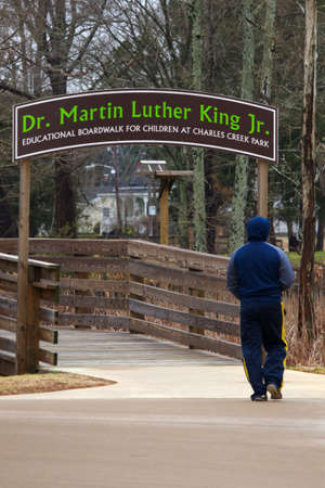 Elizabeth City, NC, USA January 26, 2021, Man walking to the   Educational Boardwalk for Children at Charles Creek Parkのeditorial素材