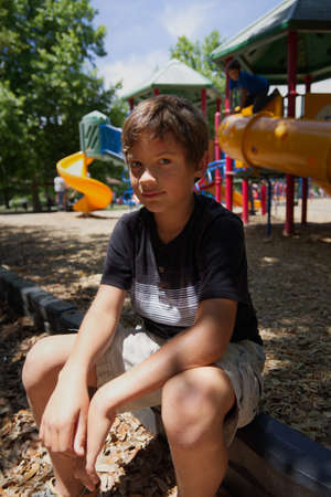 Young Boy Sitting at The Parkの写真素材