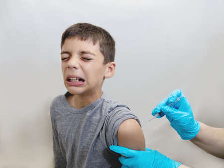 Scared and Crying Boy Getting Vaccineの写真素材