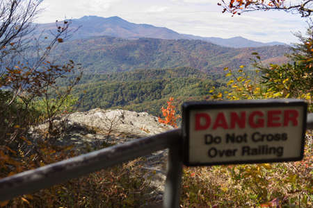 Do Not Cross Over Railing Danger Sign in the Mountainsの写真素材