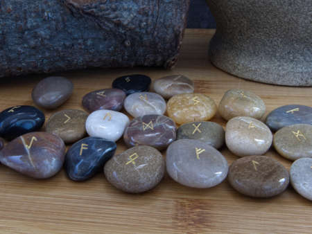 Rune Stone Set on Wooden Background with Gold Lettersの写真素材