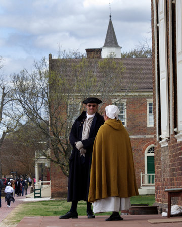 Williamsburg, Virginia, USA - 3-27-2022:  two people dressed in colonial clothing in Williamsburg. Today, in modern Williamsburgのeditorial素材