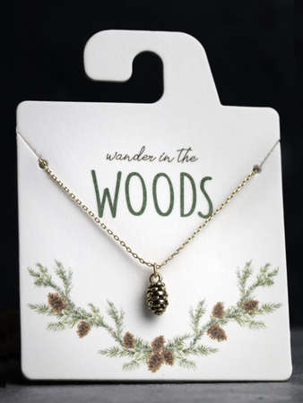 Gold Pinecone Jewelry on Board.  Wander in the Woodsの写真素材