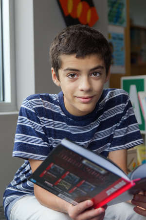 Young Boy with a book at a libraryの写真素材