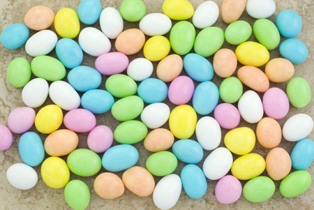 A full frame horizontal background of pastel colored Easter egg candies