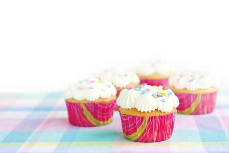 Delicious Easter cupcakes on a pastel spring colored placemat, horizontal with with copy space and selective focusの写真素材