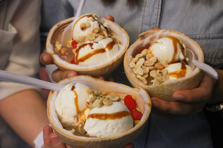 Coconut Ice Cream in Coconut with Peanuts, Red Ruby and Gula Melakaの写真素材