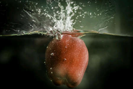 An apple be dropped into water.の素材