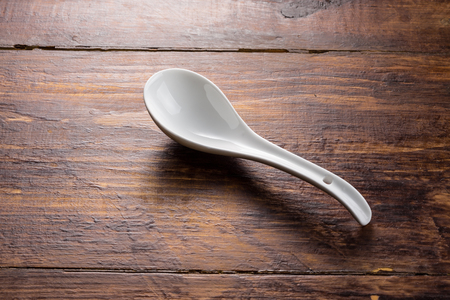 ceramic spoon on the wooden background table topの写真素材