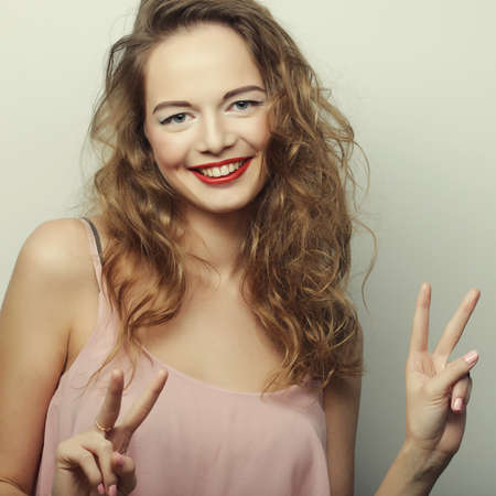 young expression woman over gray background, happy timeの写真素材