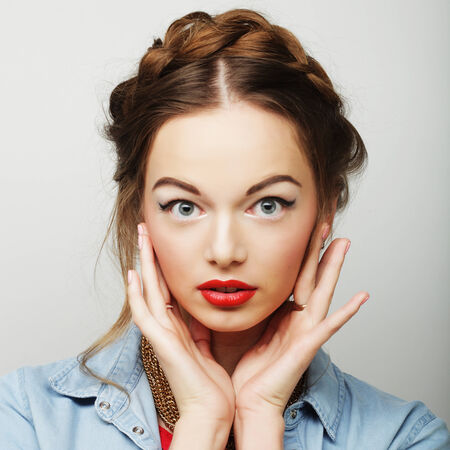 Beautiful young surprised blond woman. Studio shot.の写真素材