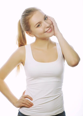 smiling woman in blank white t-shirt isolated on whiteの写真素材