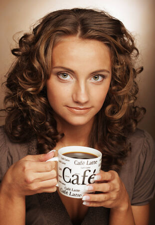young pretty woman drinking coffeeの写真素材