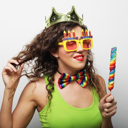young lovely woman with crown and funny sunglassesの写真素材
