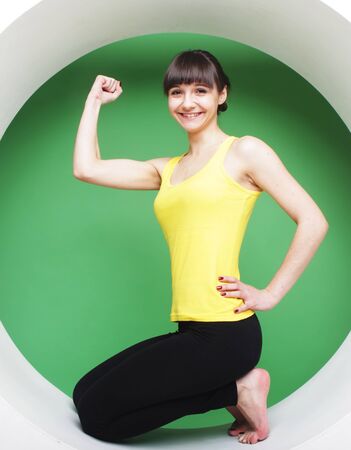 sporty girl posing in green circleの写真素材