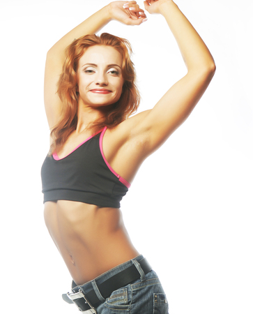 sporty woman is showing her strong hands on gwhite backgroundの写真素材