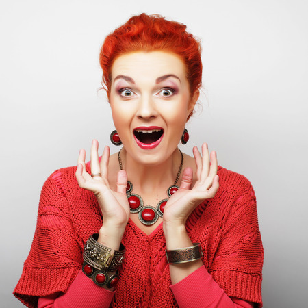 Beautiful young surprised woman. Studio shot.の写真素材