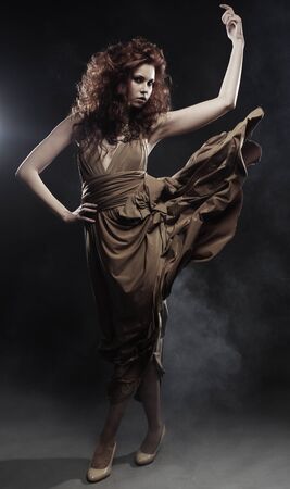 beautiful young woman in beige long dressの写真素材