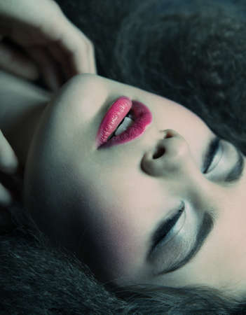 Glamour portrait of beautiful woman model with  bright  makeup and romantic wavy hairstyleの写真素材