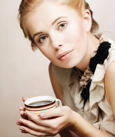 young pretty woman drinking coffeeの写真素材