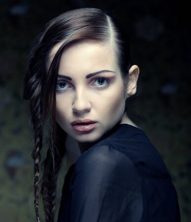 close up portrait of beautiful young blonde woman with creative braids hairdoの写真素材