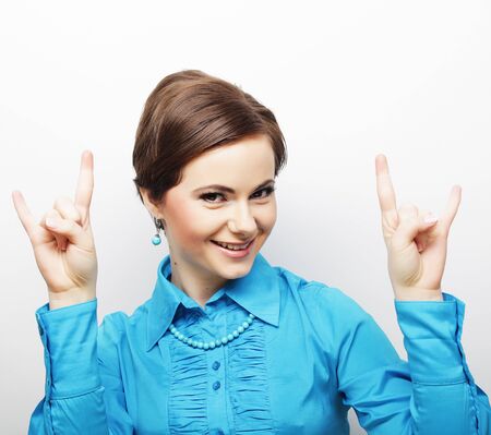 Successful happy girl gives thumb up with two handsの写真素材