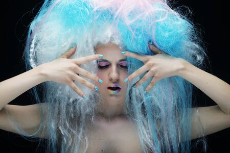 close up portrait young woman with bright make up and creative hairの写真素材