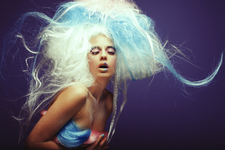Young fashion model with bright make up and colorful hairの写真素材