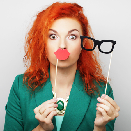 Attractive playful young woman ready for party - falce lips and glasses\rの写真素材