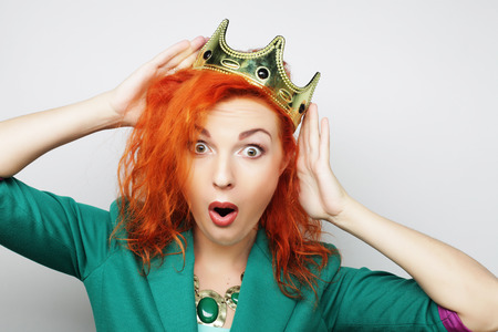 young lovely redhair woman in crownの写真素材
