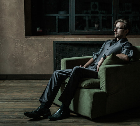 Businessman sitting on an armchair. Fahion man.の写真素材